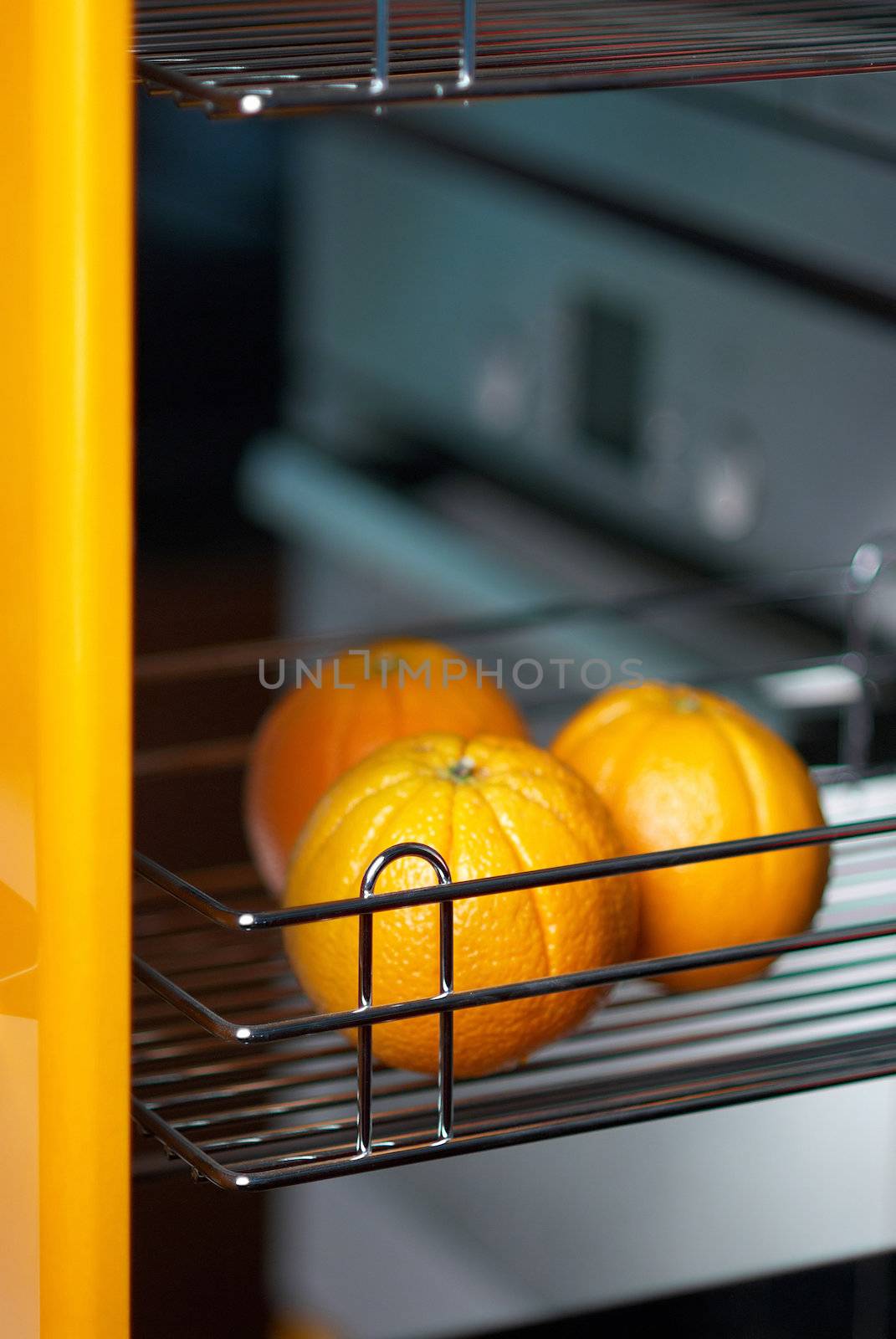 Tasty orange in kitchen in fridge