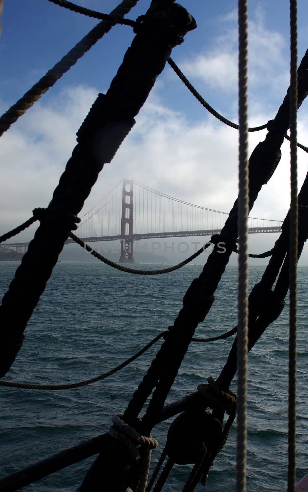 Golden Gate Bridge viewed through a sailing ships rigging when leaving the bay.