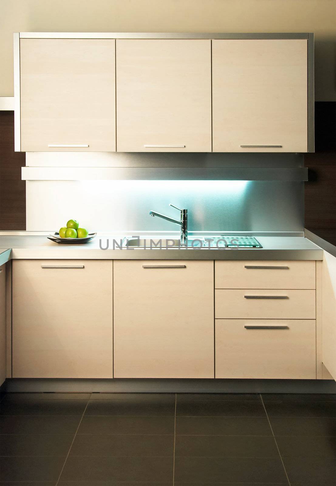 Modern stainless steel tap in white kitchen