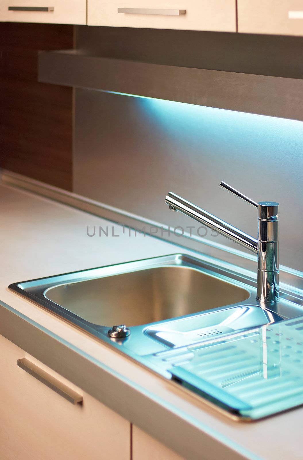 Modern stainless steel tap in white kitchen