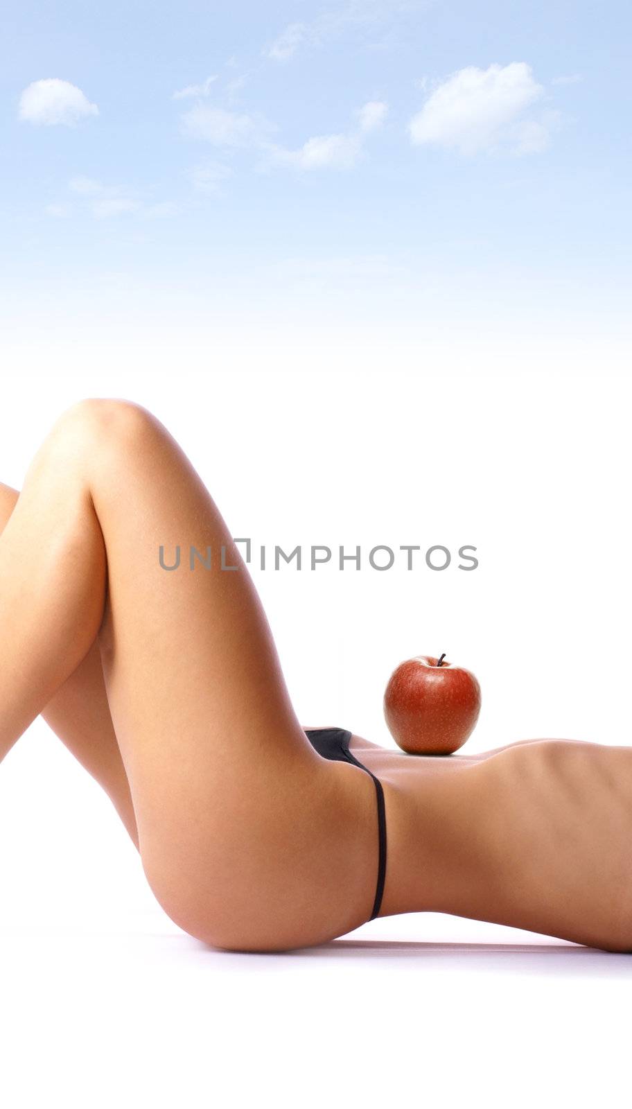 Apple on the belly of beautiful woman isolated on white concept