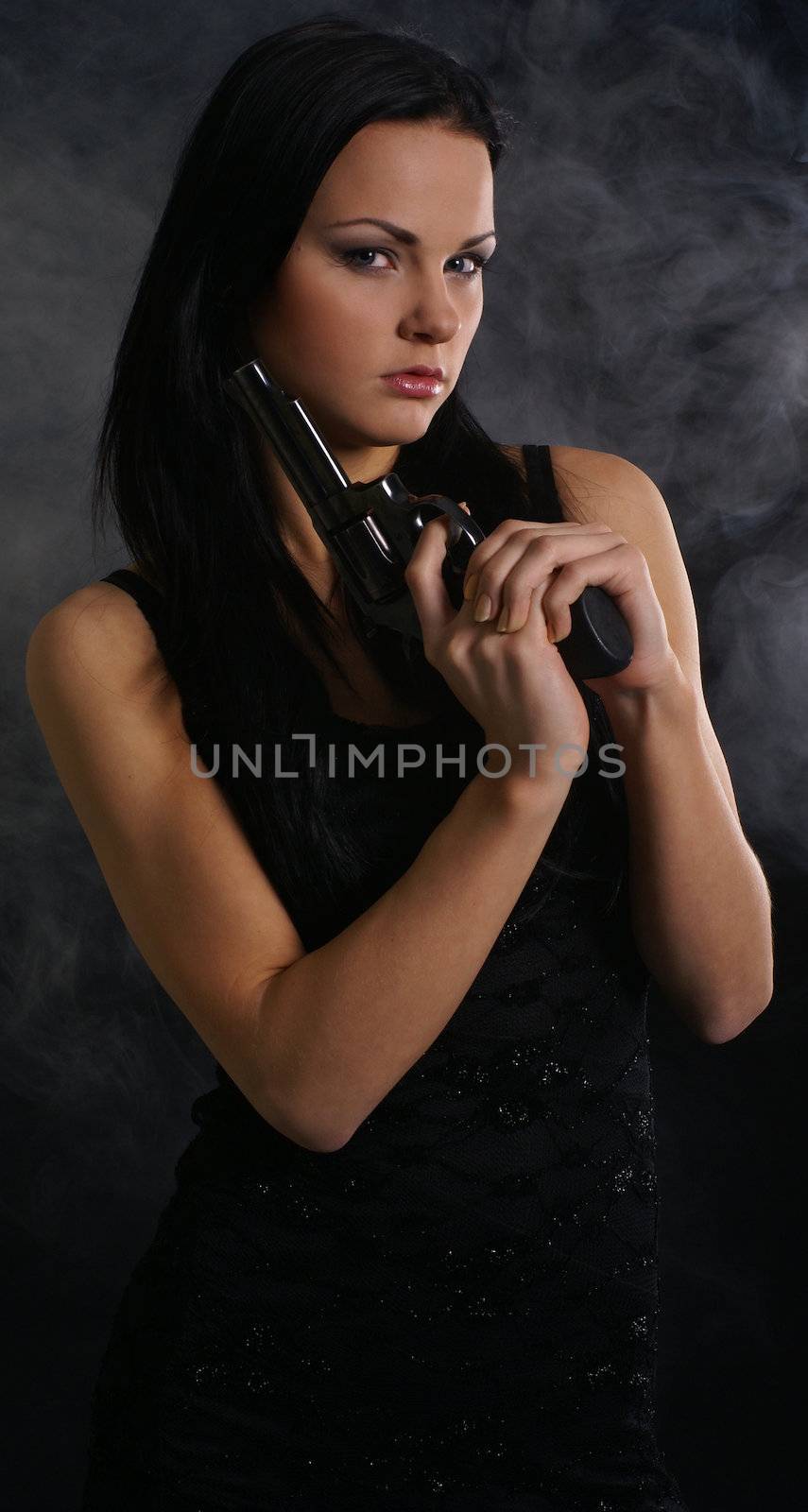 Sexy woman with weapon on smoky background