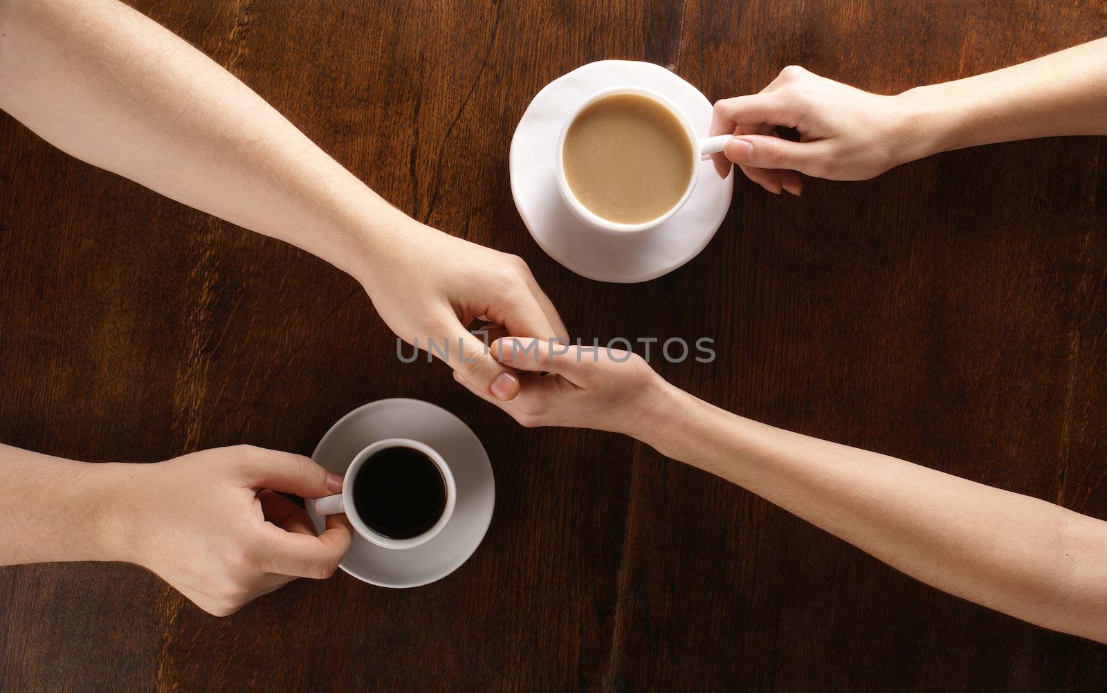 Concept of male and female hands, love and coffee              