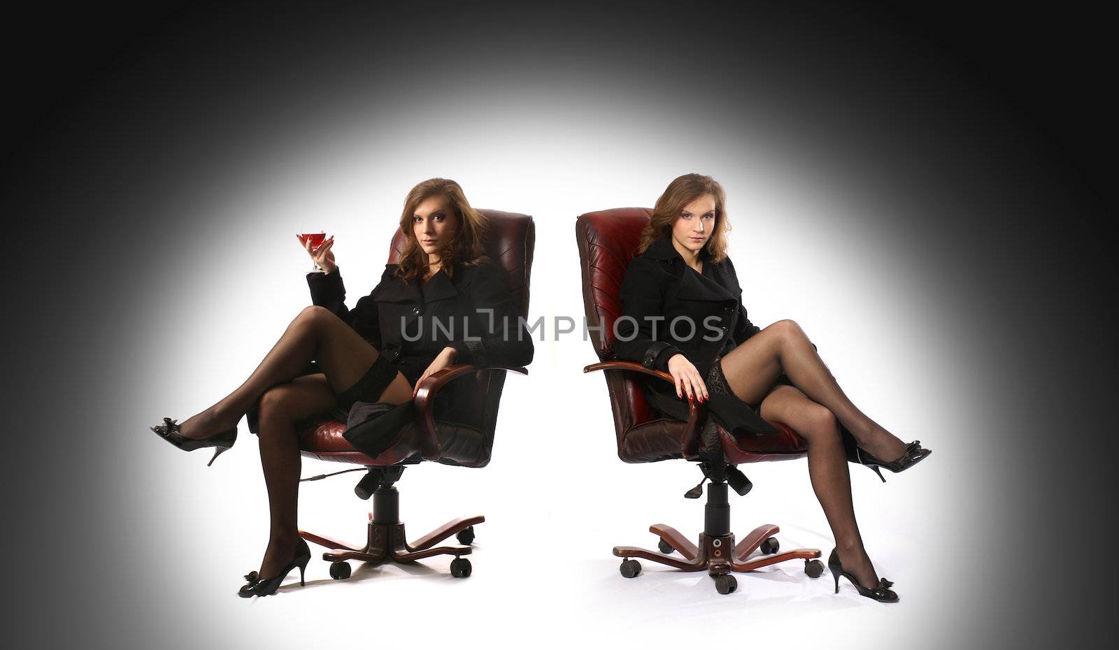 Sexy twins wearing stockings isolated on white and grey