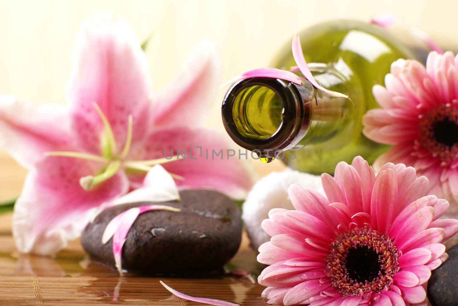 Bottle of massaging oil over spa background           