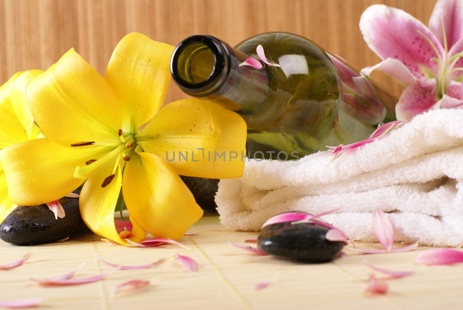 Bottle of massaging oil over spa background           