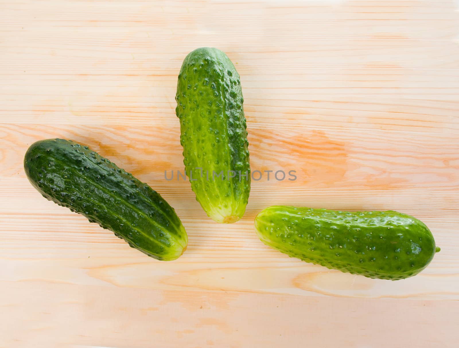 Fresh cucumbers on a wooden board