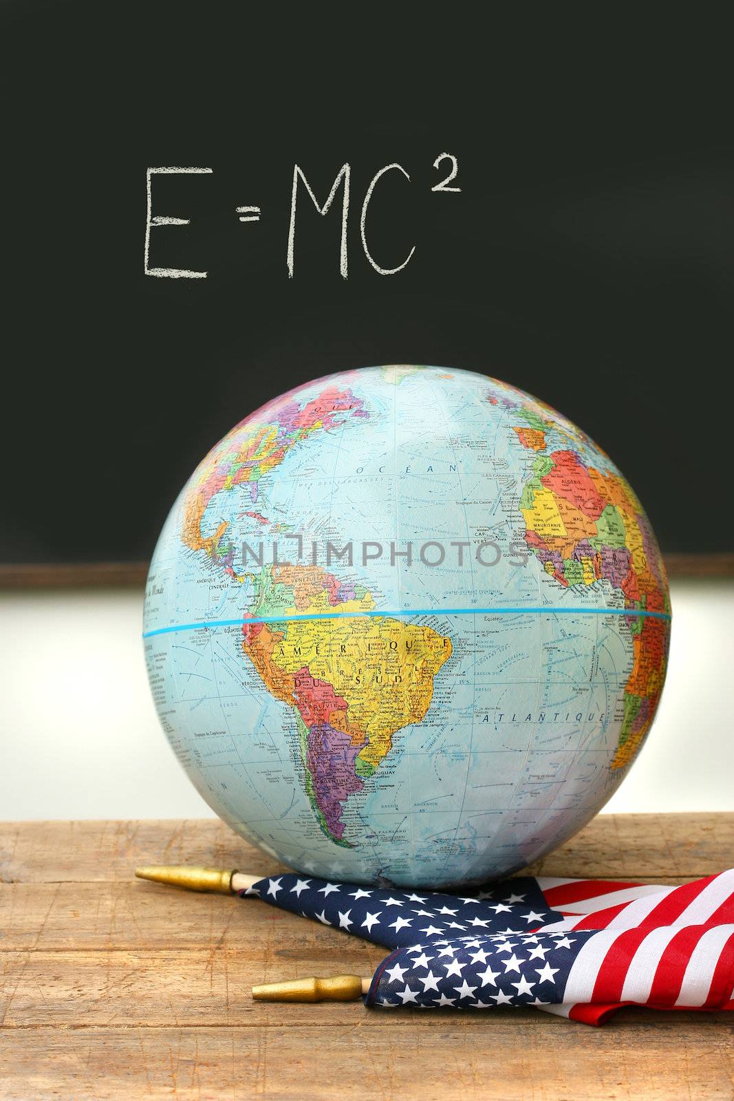 Globe and American flag on old school desk