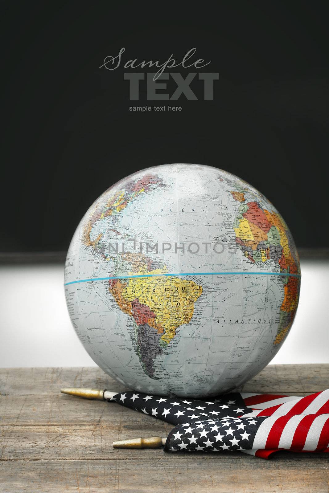 Globe and American flag on old school desk
