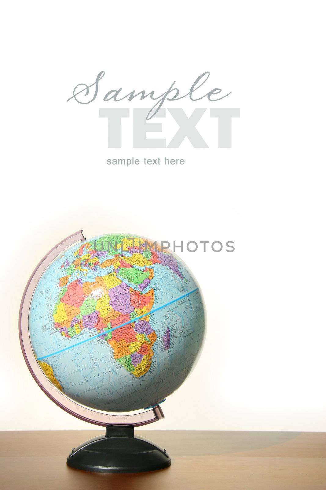 Globe with stand on desk against white background
