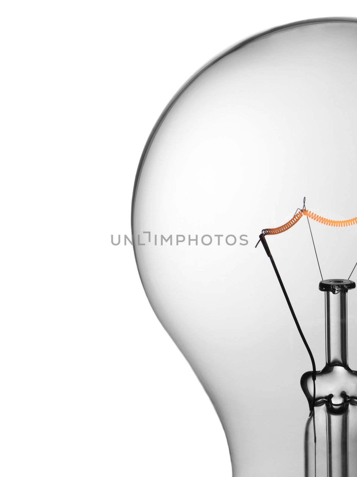 Close up of a transparent light bulb over a white background.
