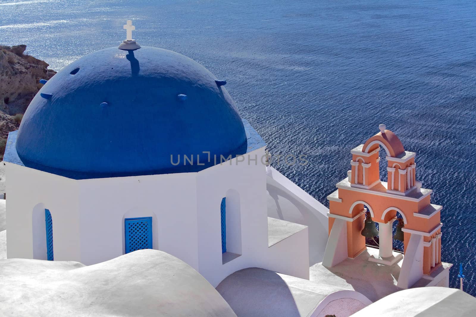 Blue and white domed church rooftop with ocean view Oia, Santorini, Greece