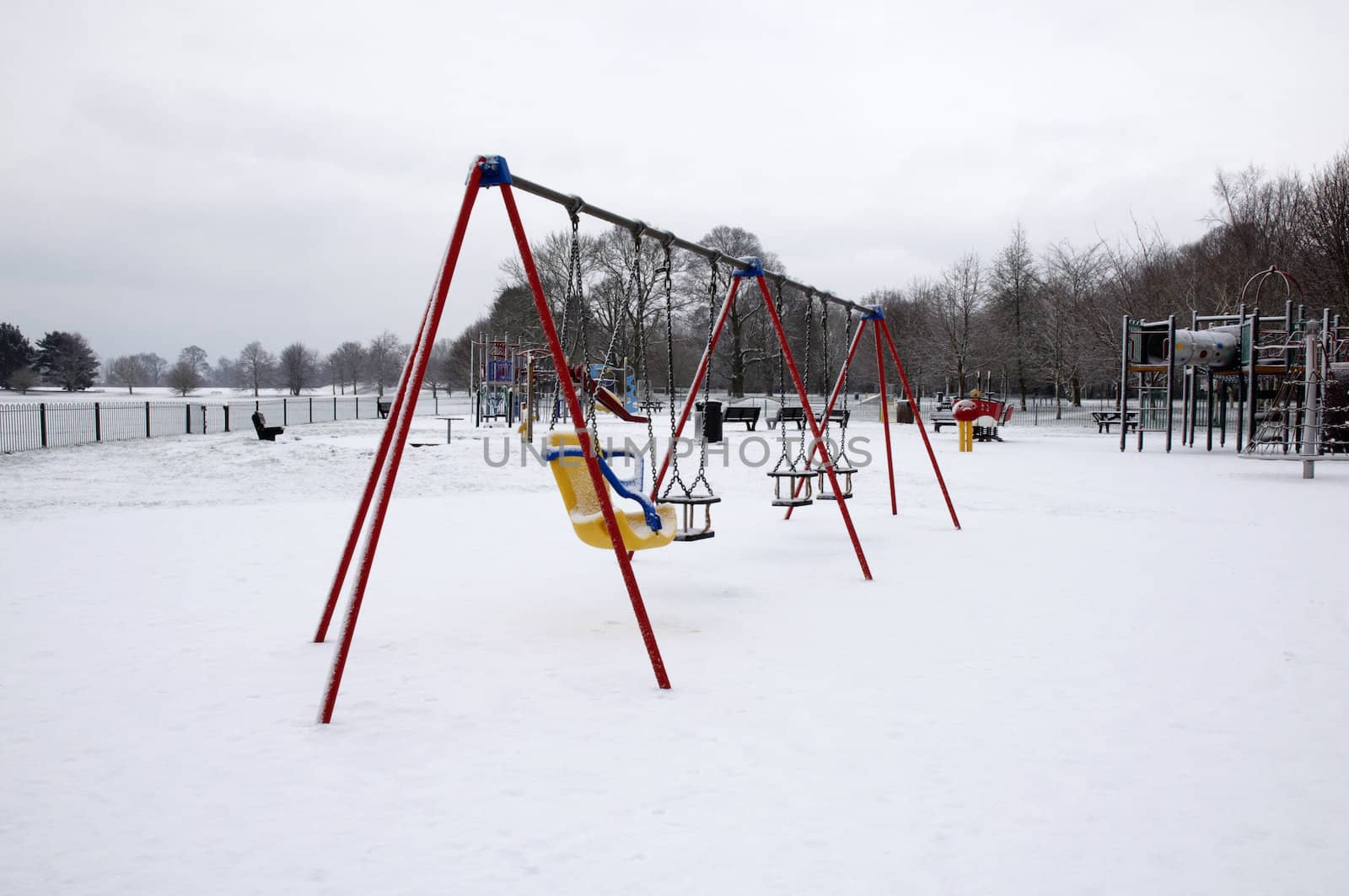 Swings in a plygrond covered in snow