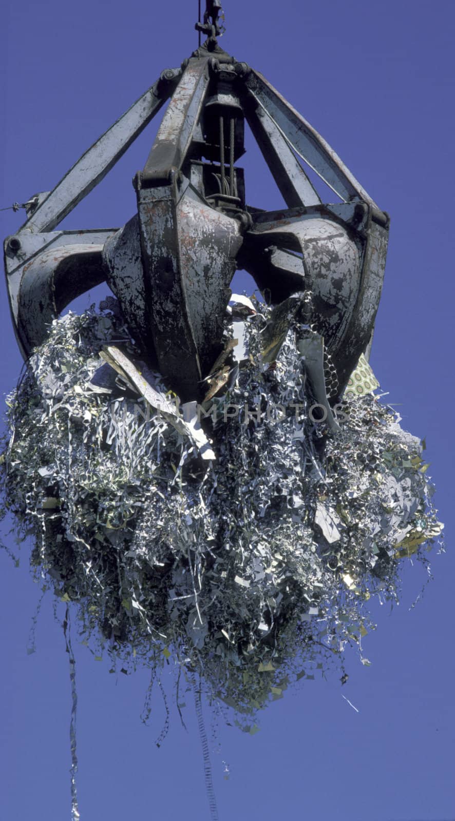 crane lifting metal pieces for recycling