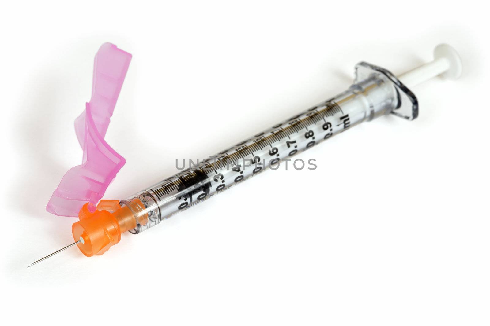 A macro image of a medical vaccination syringe with attached cover for safe disposal.
