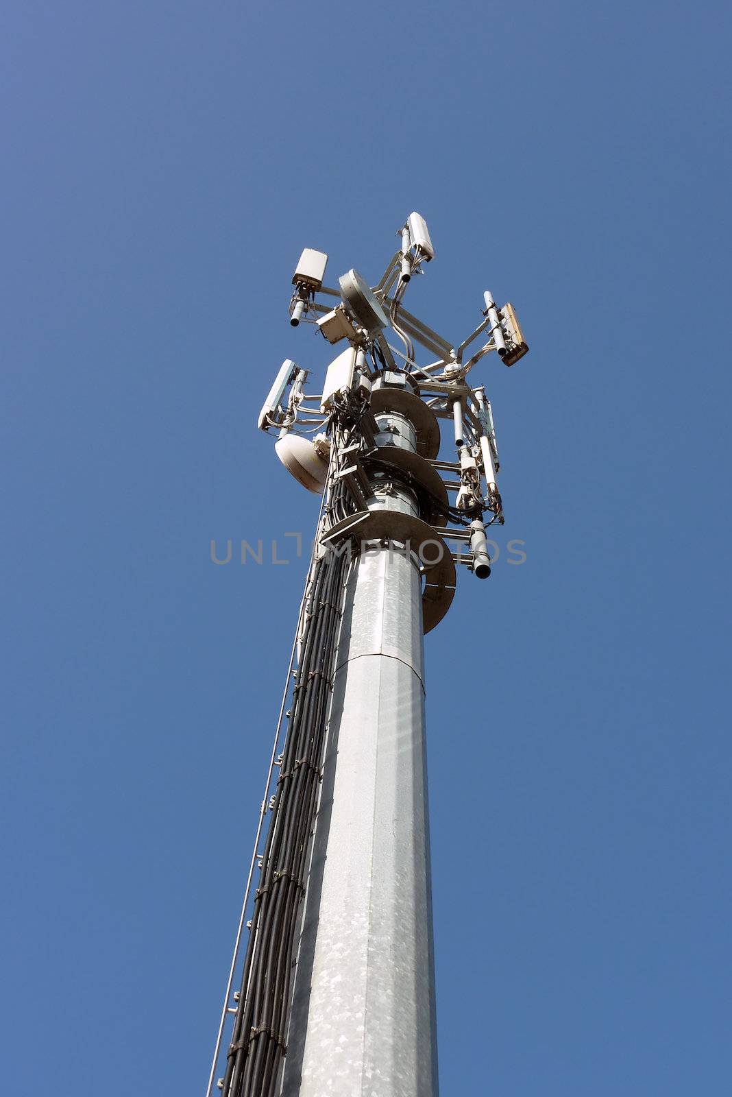 View of communication tower in cloudless blue sky