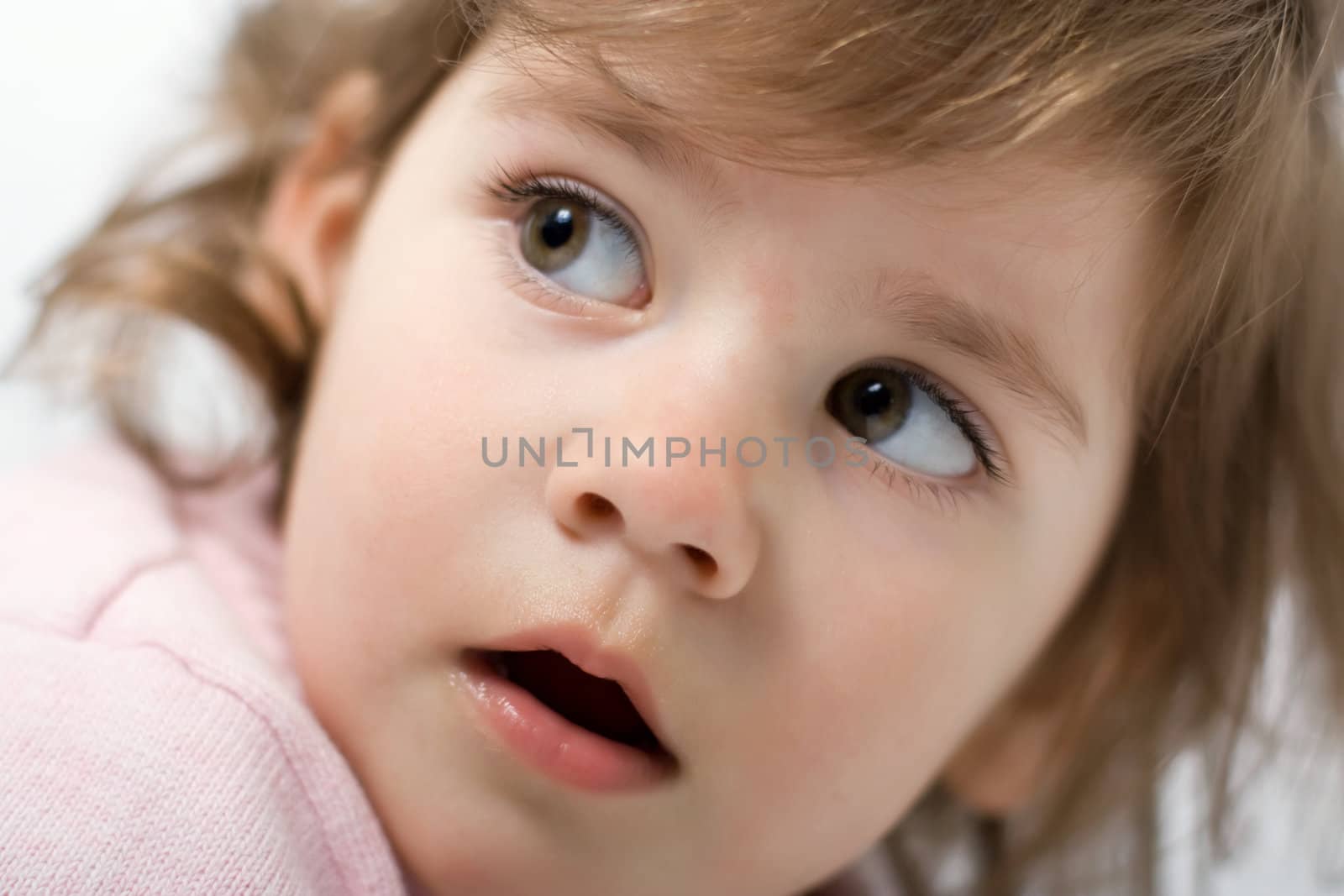 little girl looking over shoulder, with open mouth