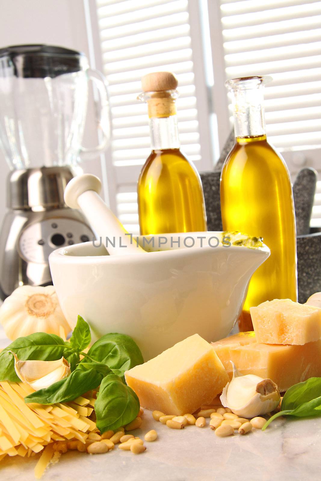 Ingredients for making italian pesto with pine nuts, basil,garlic, parmesan  cheese with motar and pestle