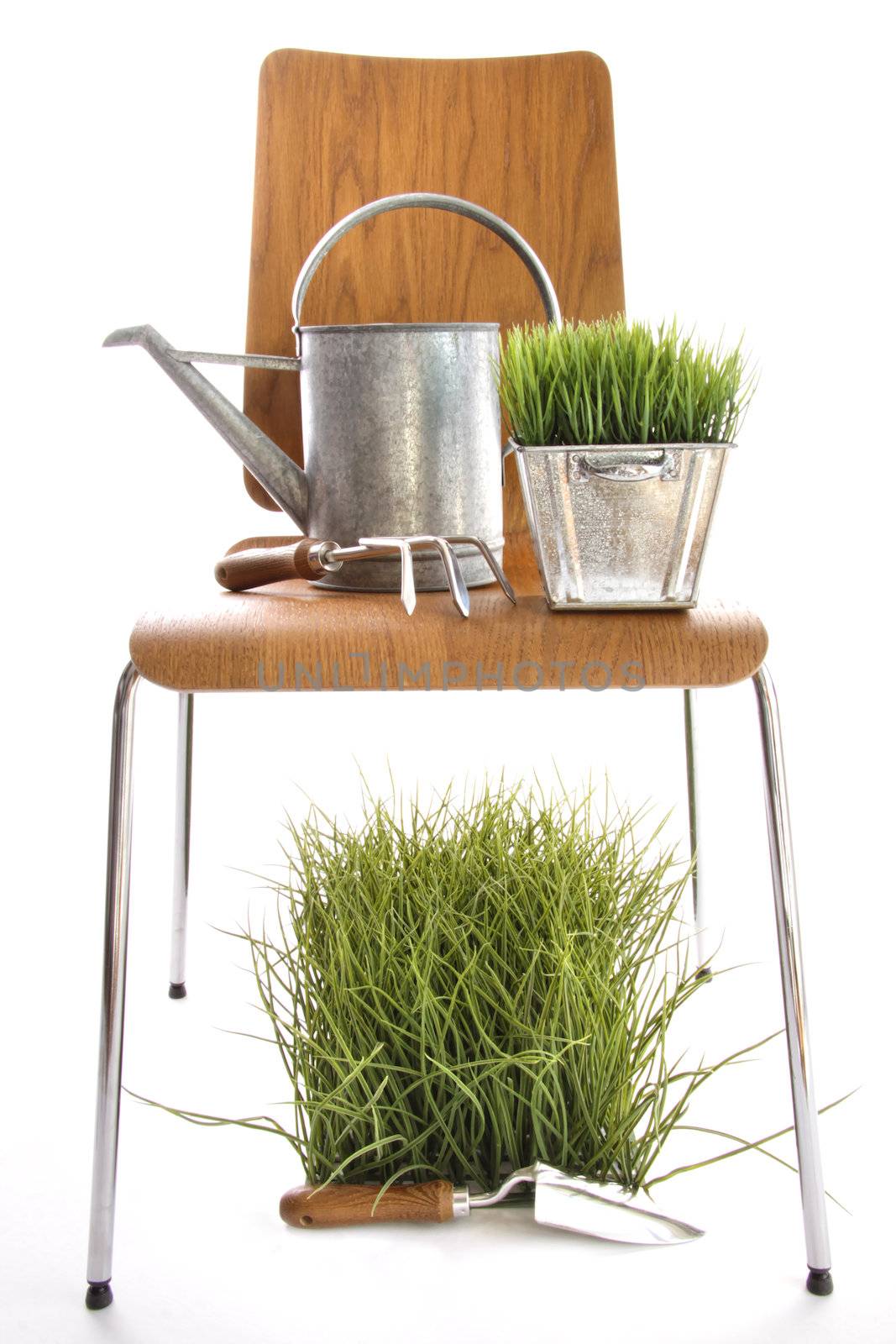 Garden tools, watering can on wood chair  by Sandralise