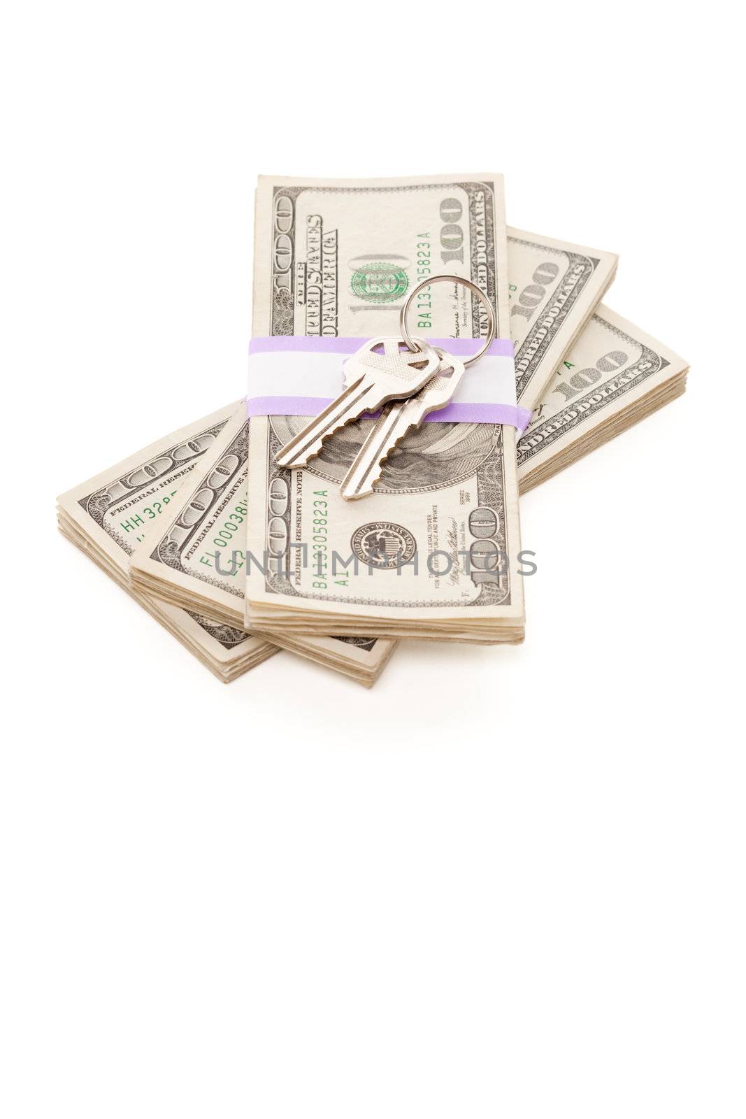 House Keys on Stack of Money Isolated on a White Background - Cash for Keys Program.