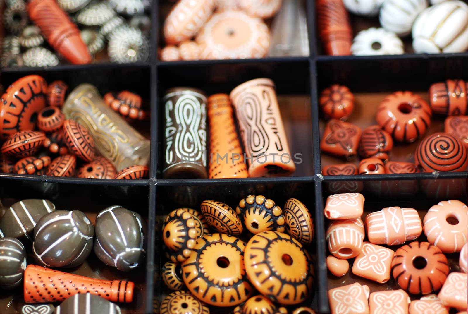 A box of numerous beads in a traditional African style