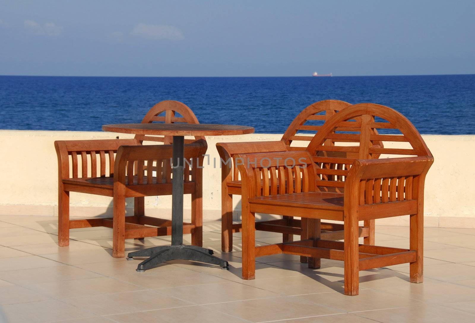wooden chairs on terrace in summer resort in Turkey by Mediterranean sea