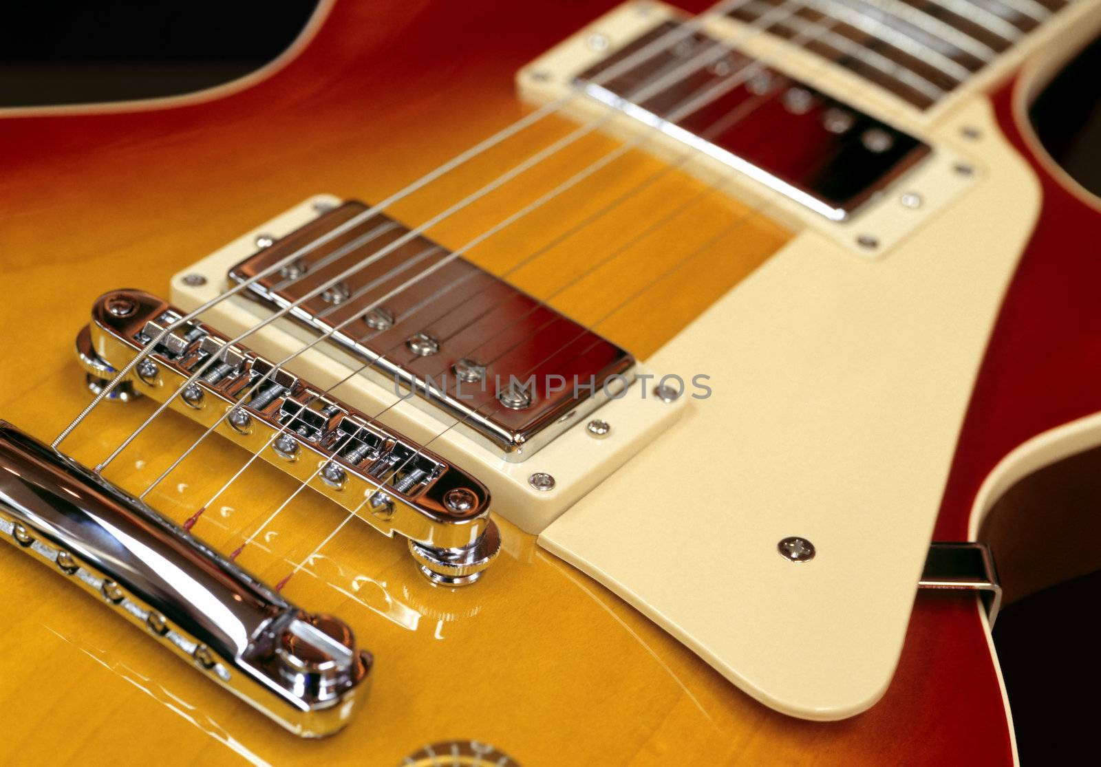 Closeup of the pickups on an electric guitar.
