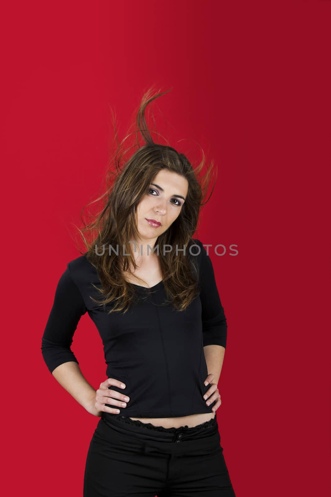 Portrait of a beautiful young woman on a red background