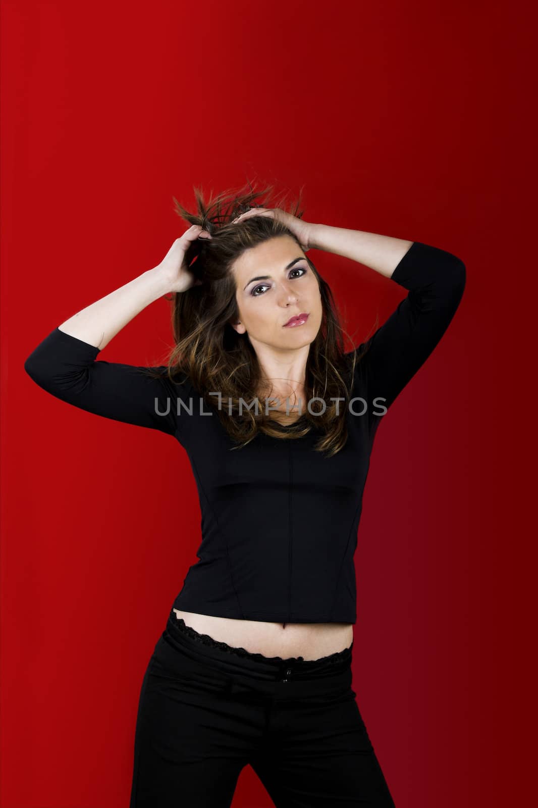 Portrait of a beautiful young woman on a red background