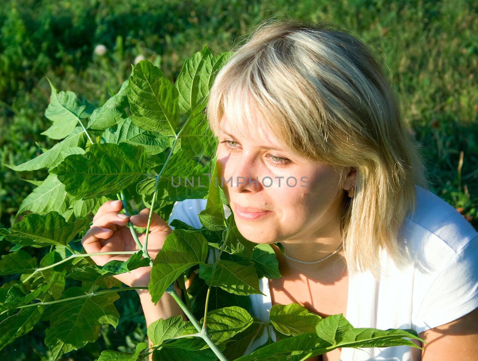 Portrait of the woman against green plants