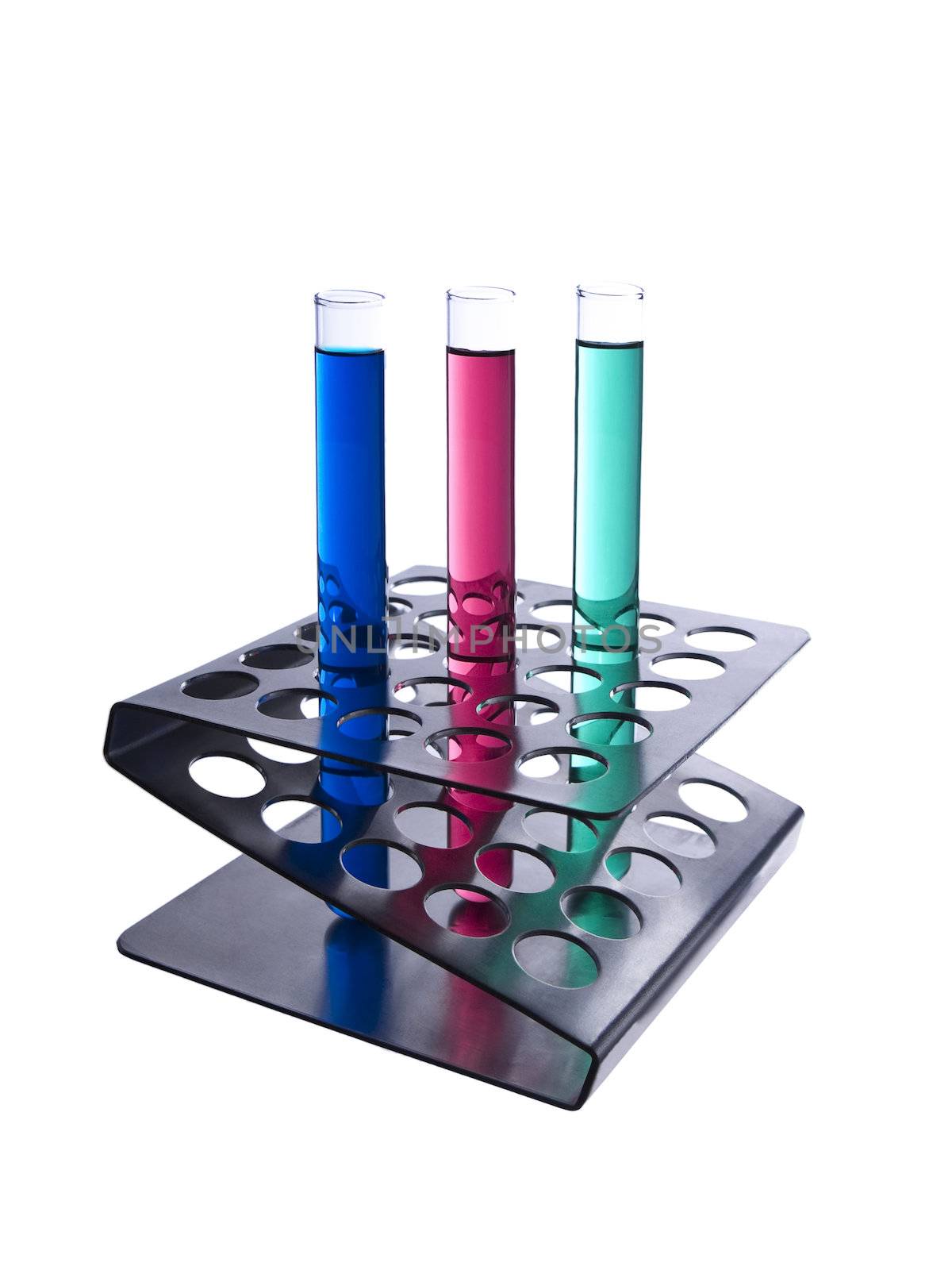 Three test tubes filled with colored liquids on a metallic rack. Isolated on white.