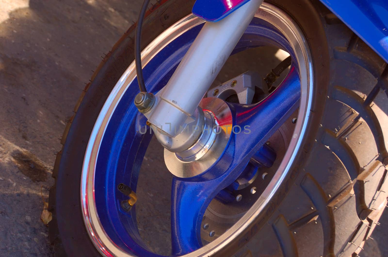 closeup of scooter wheel of blue color