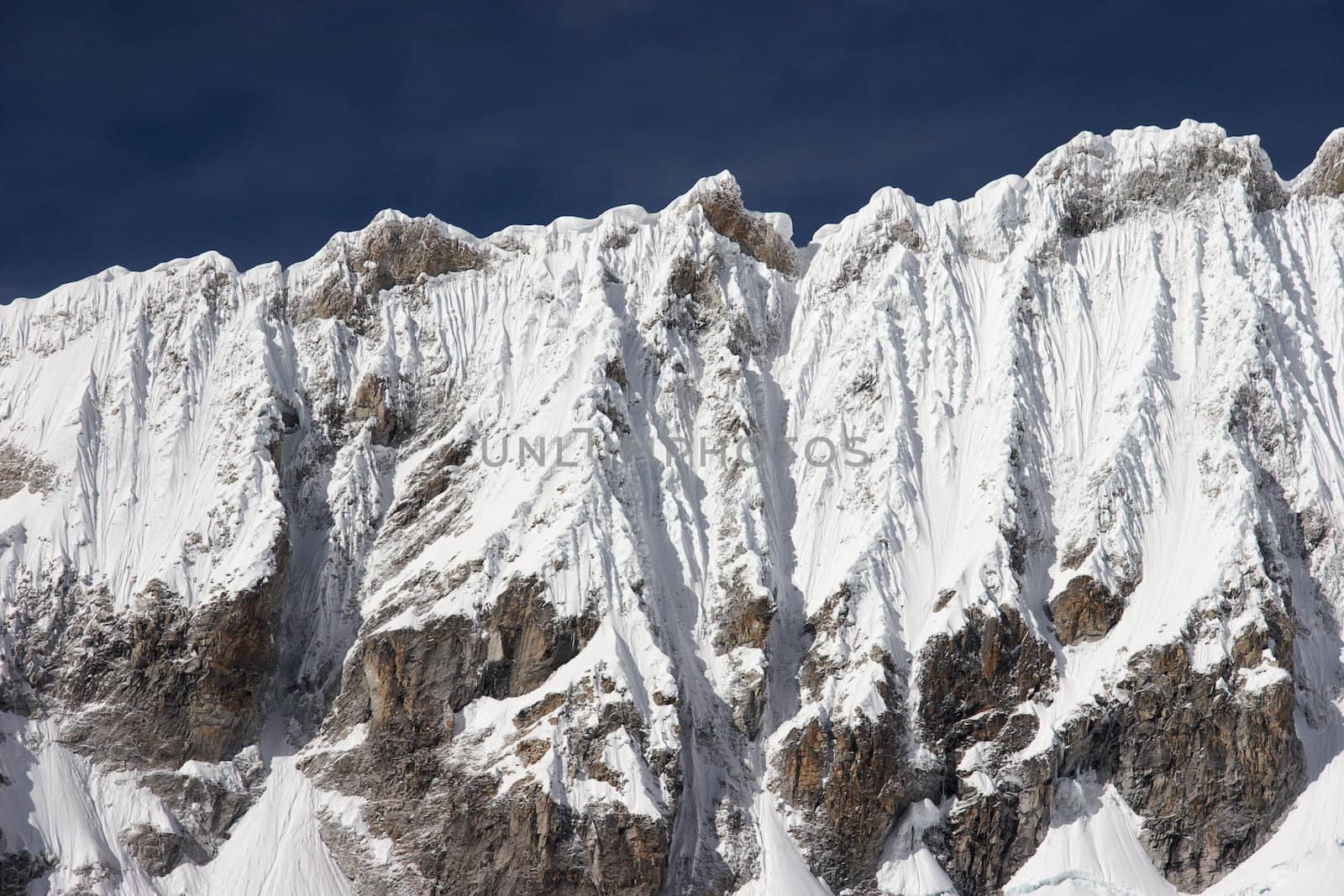 Steep mountain ridge covered with ice, Cordillera Blanca, Peru.