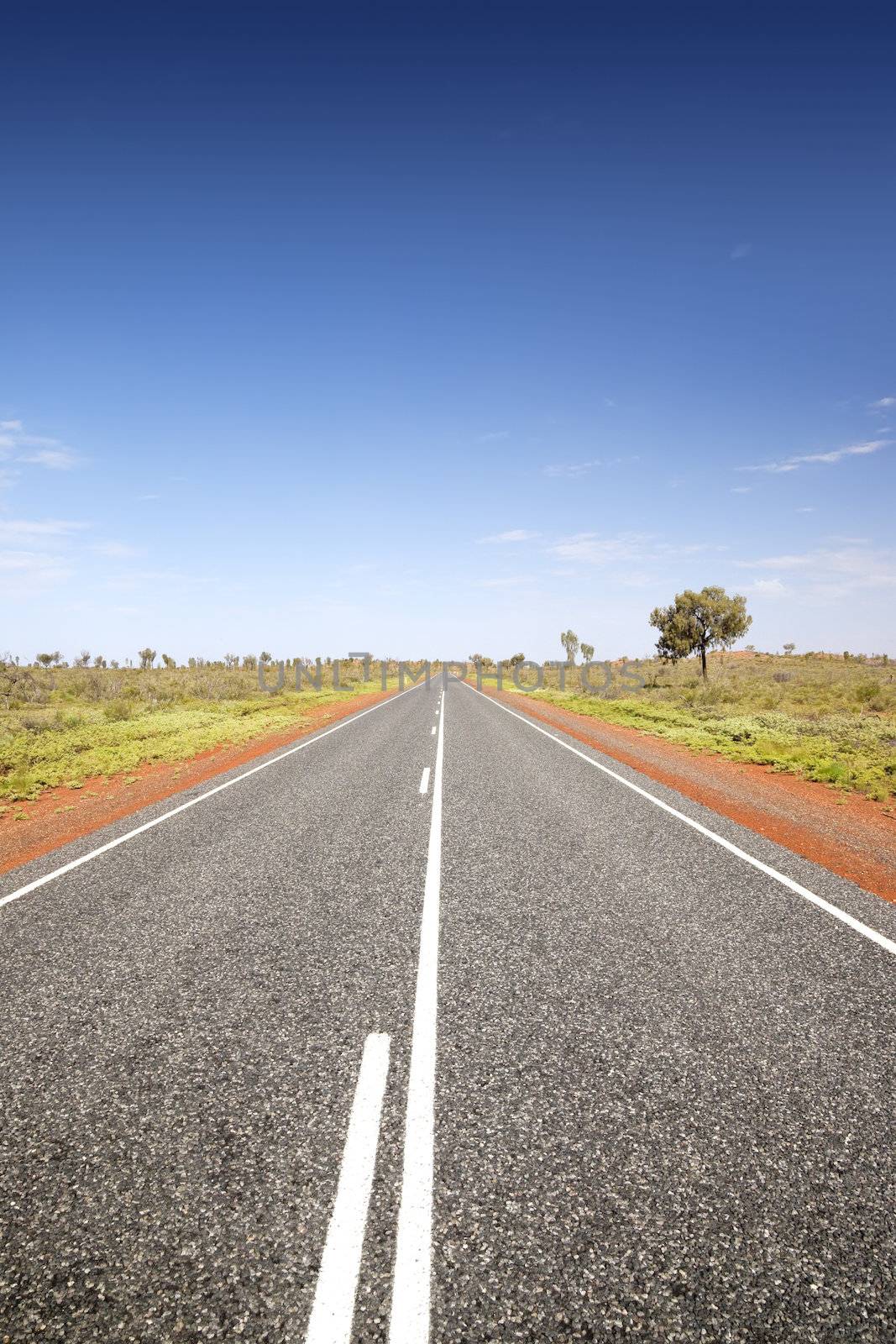 A photography of an australian road under a blue sky