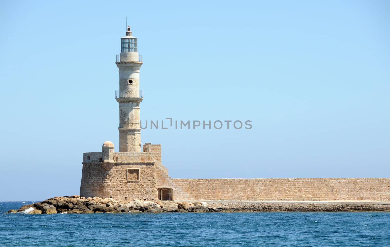 Lighthouse on the peer in the old harbor in Chania Crete