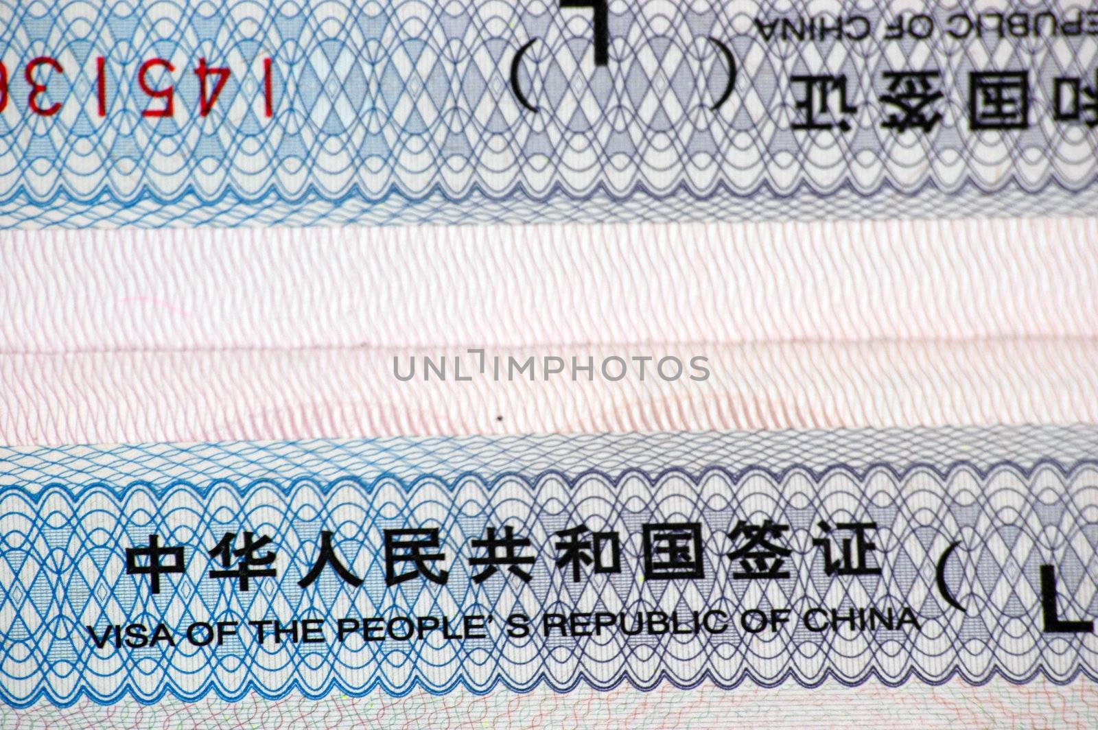 Closeup photo of Chinese visa inserted into passport.