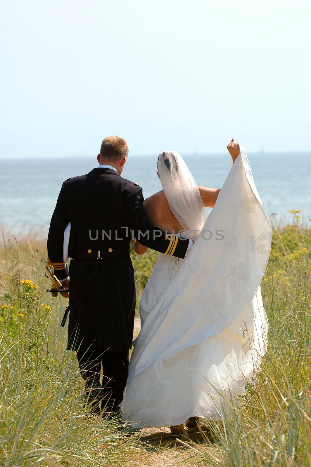 Wedding couple walking near the sea