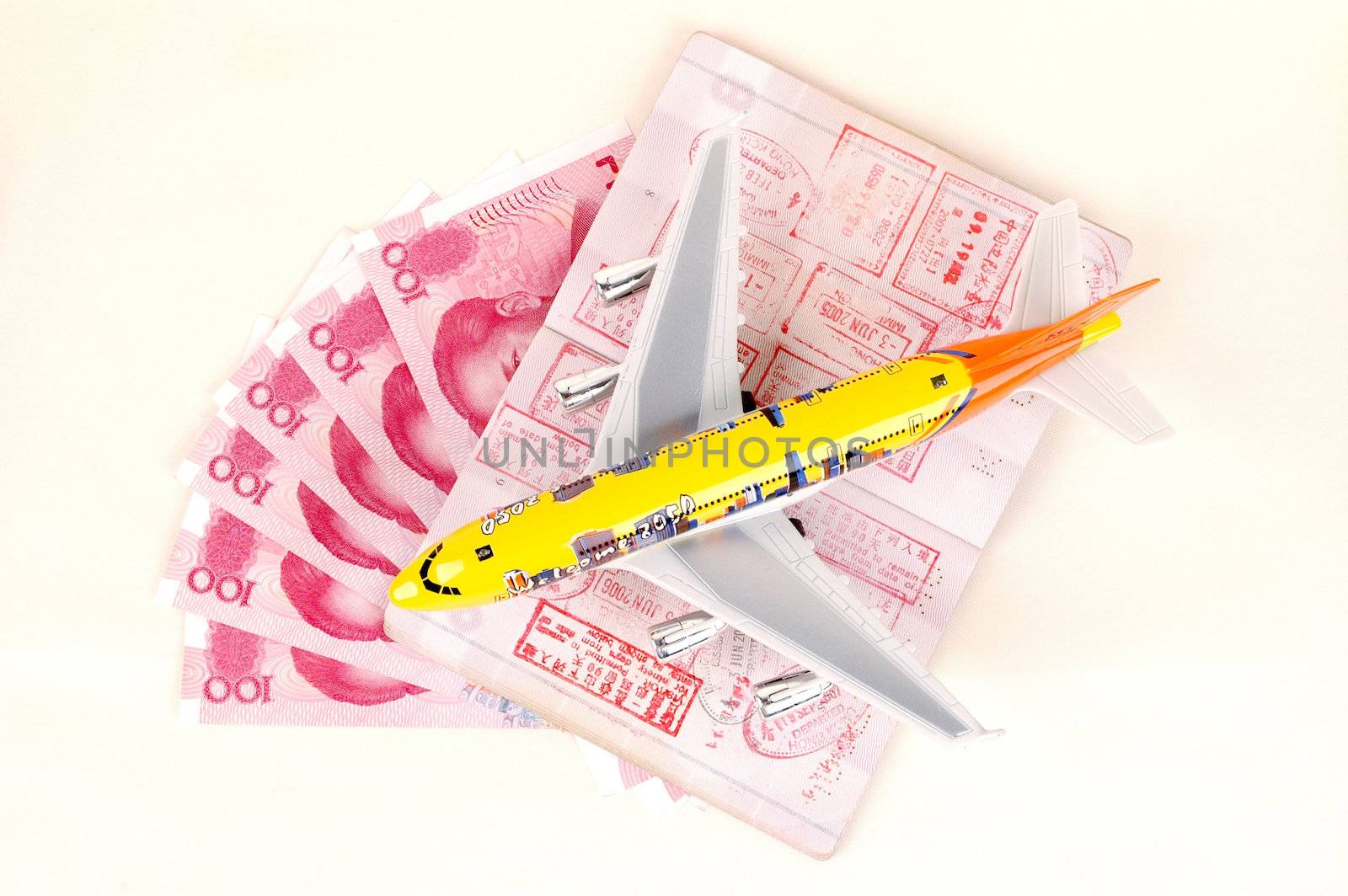 Small toy plane, passport full of stamps from Hongkong and Chinese money, RMB banknotes.