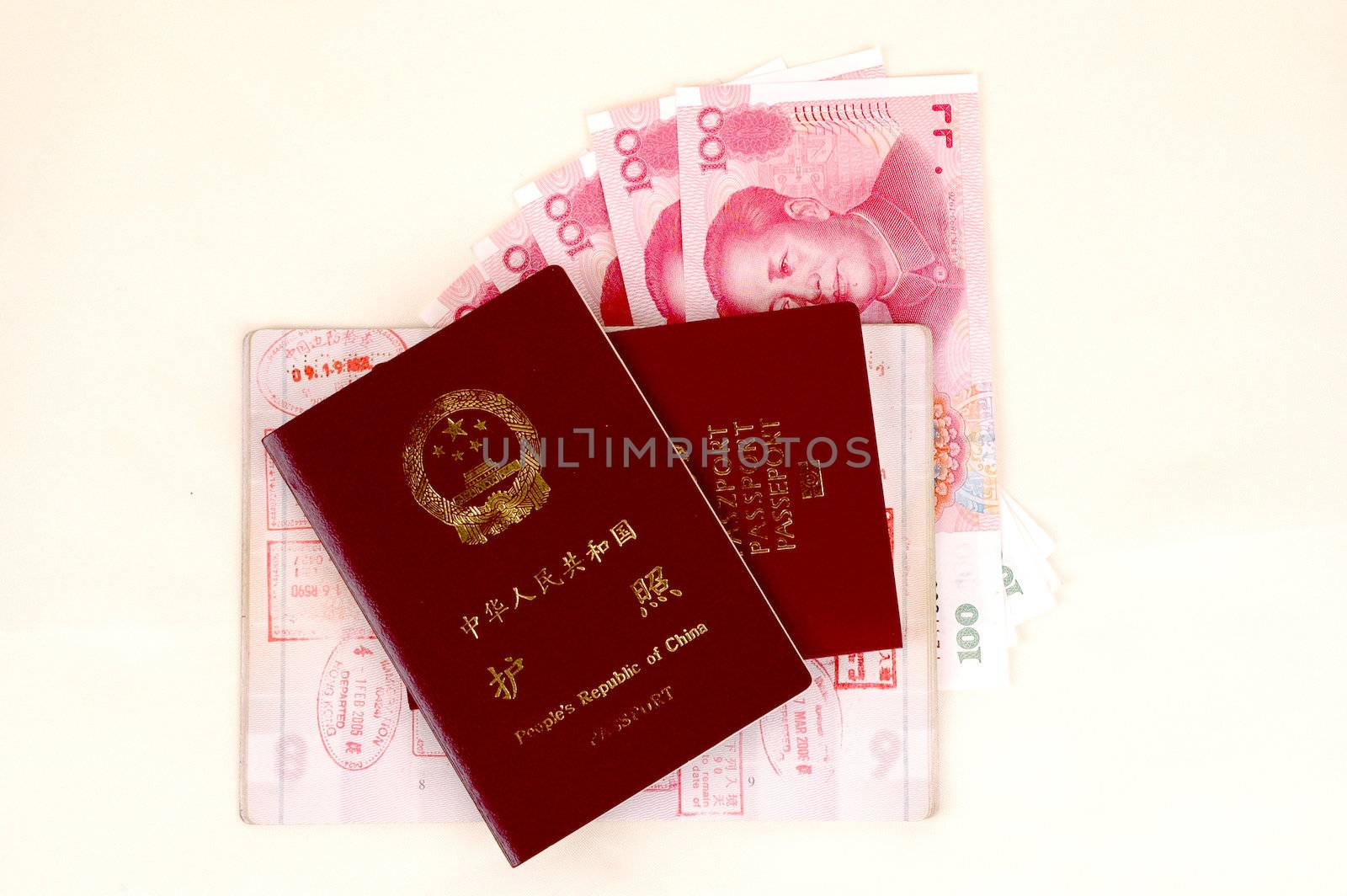 Chinese and European passport, stamps from borders and Chinese banknotes.