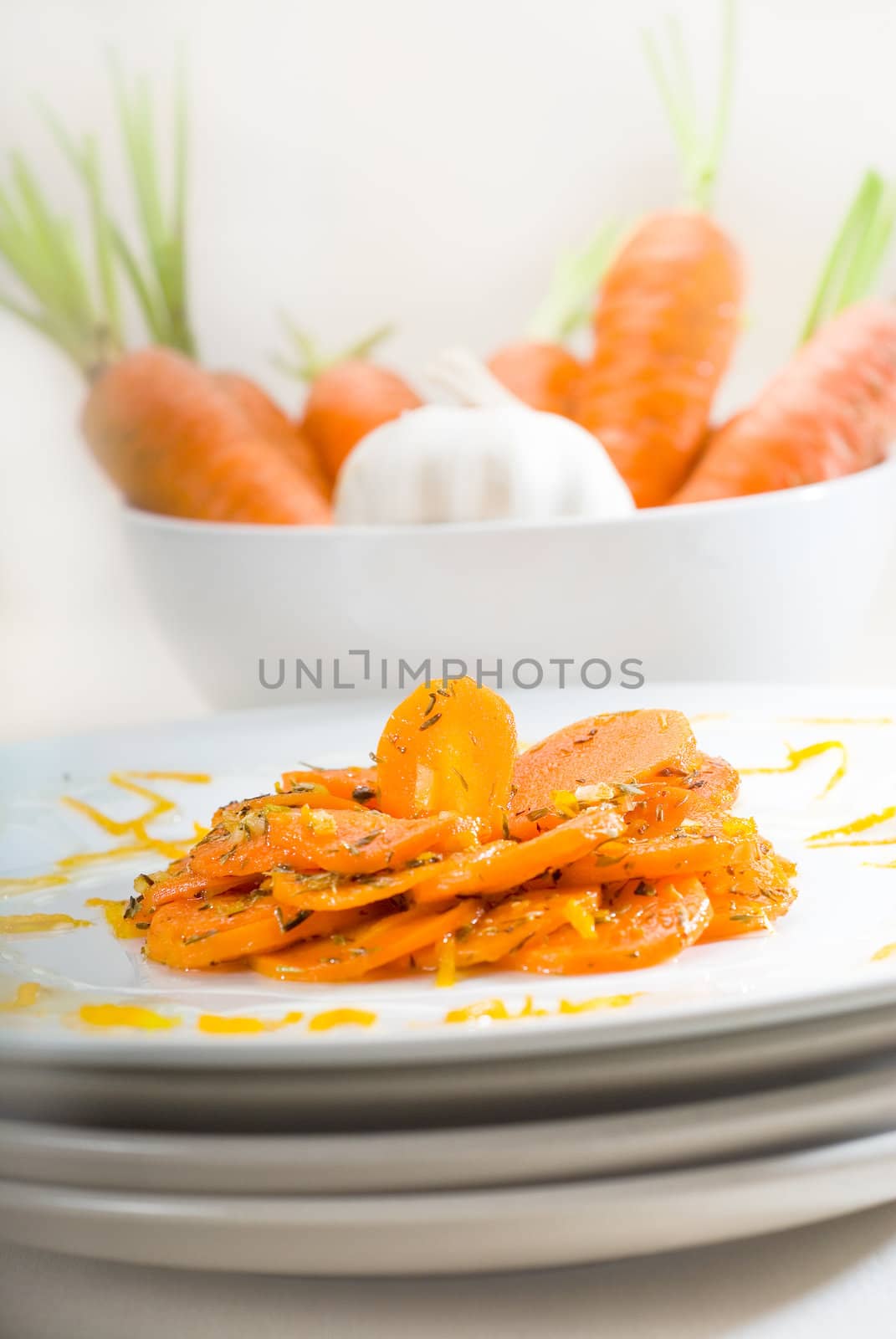 fresh  and healthy Honey glazed carrots on a plate with tyme on top