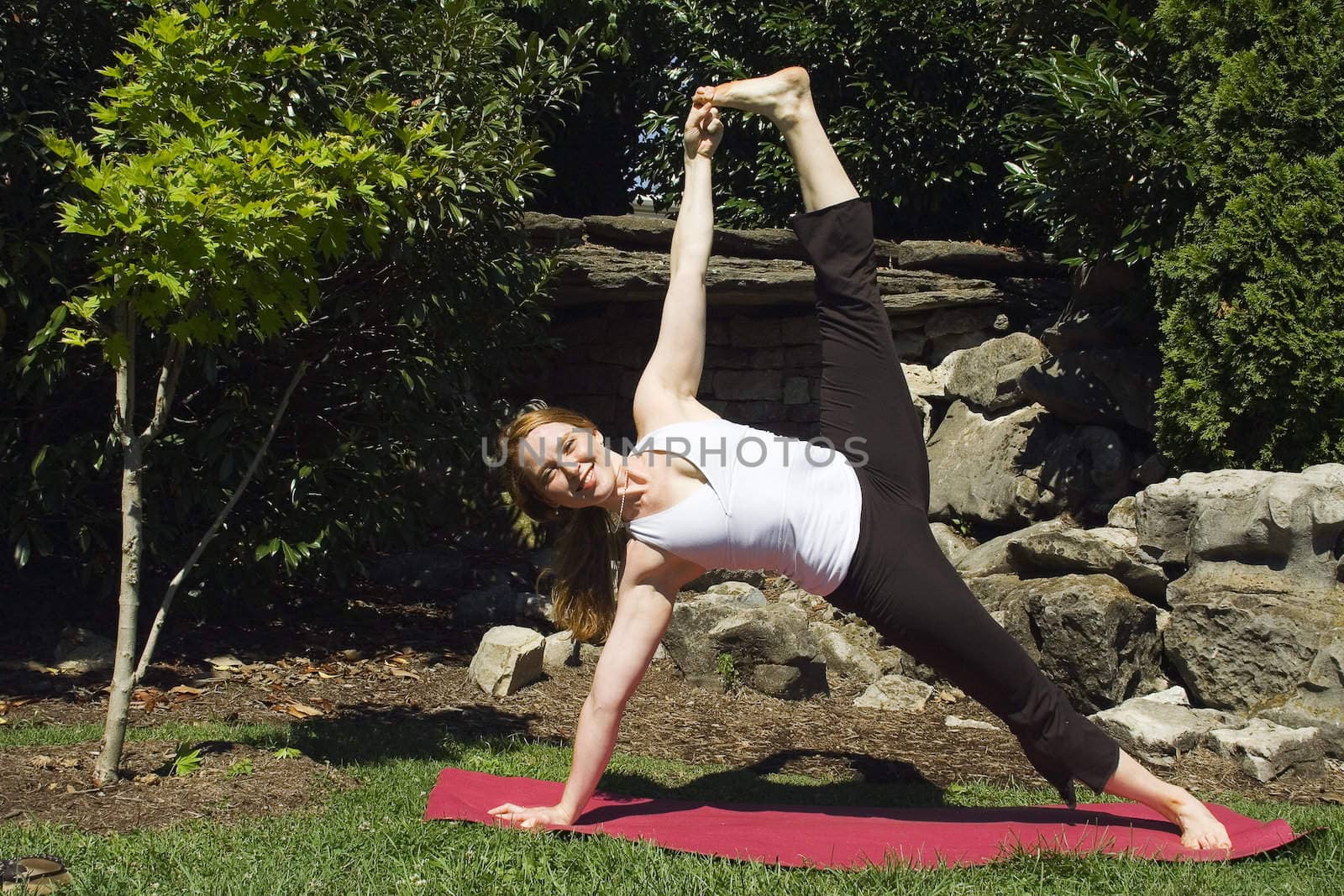 Yoga expert stretches to show her limberness for the camera.