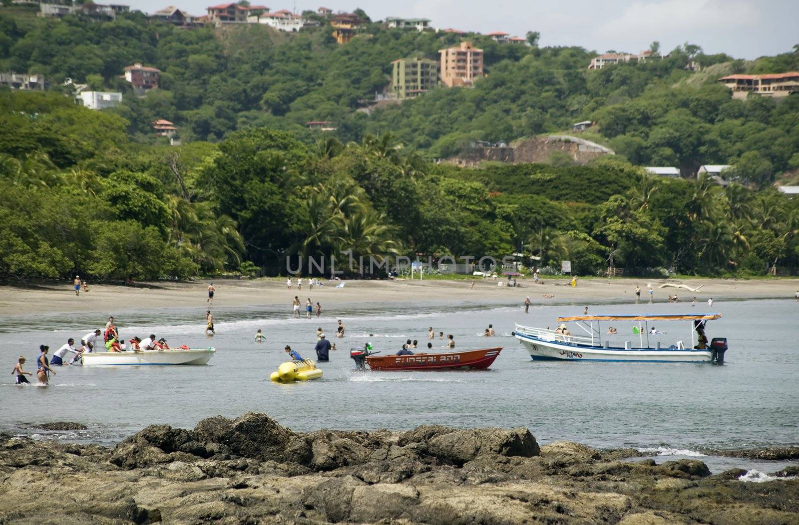 People and boats in the water at Playa Hermosa Costa Rica 