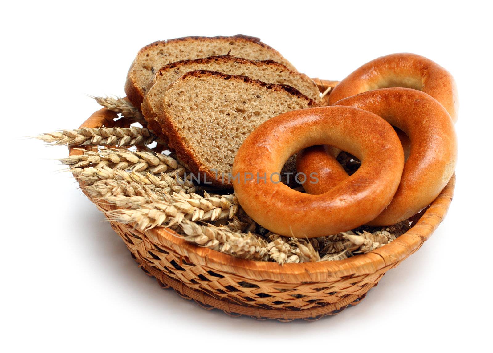 ears bread and bagels in basket isolated on white