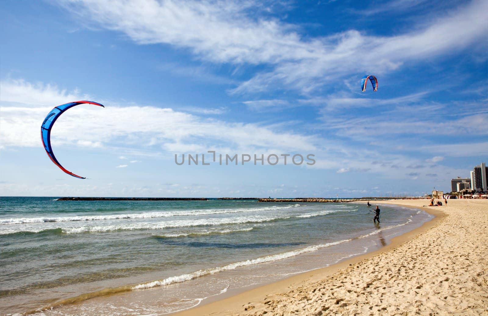 Two kitesurfers on the beach at Tel-Aviv, Israel 