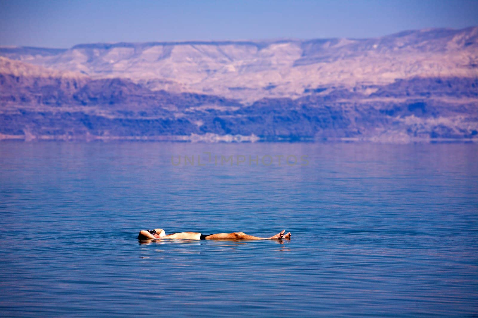 Man floating at the Dead Sea, Israel
