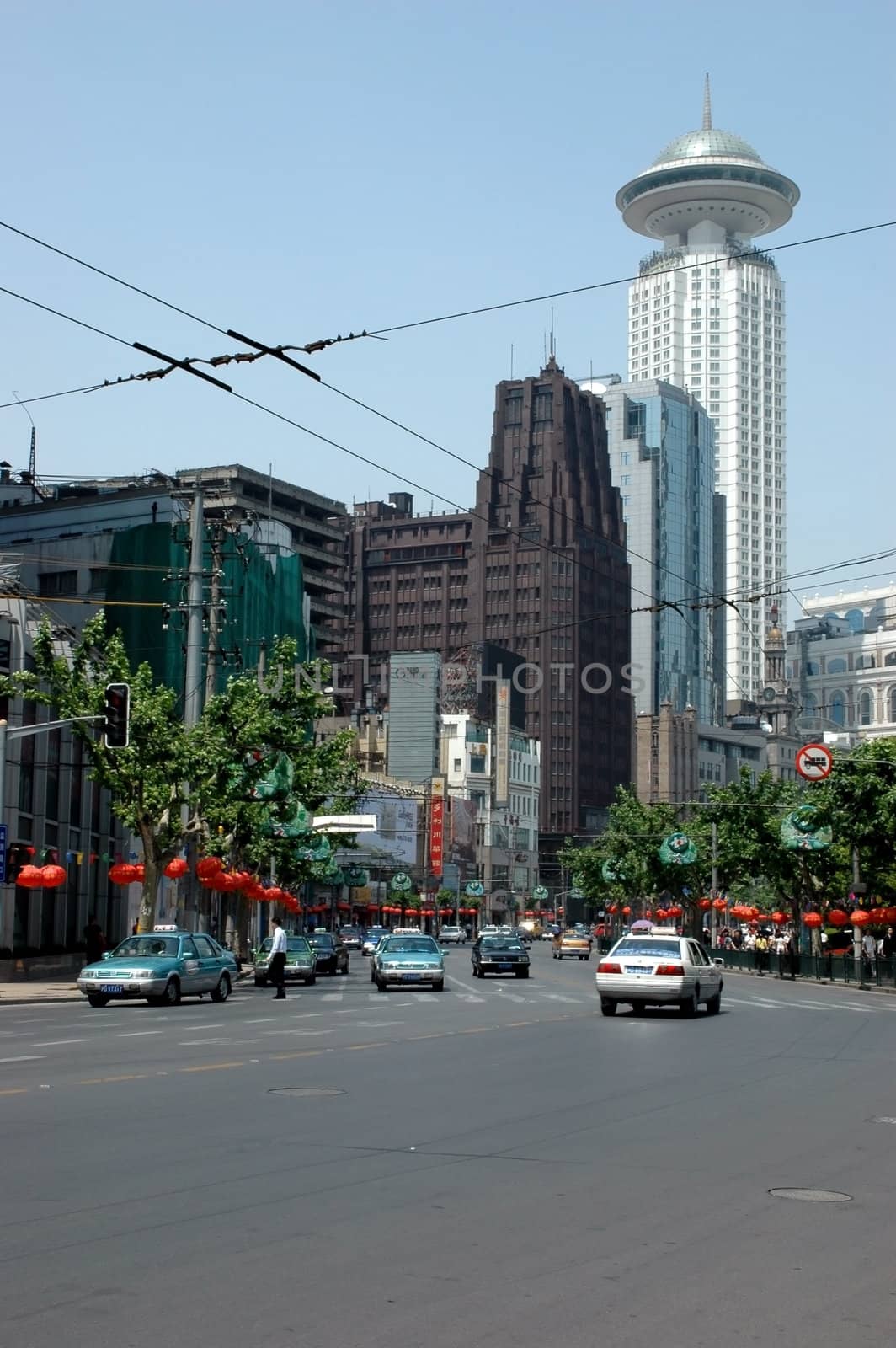 China, Shanghai city, People's Square area with eldest and modern hotels. Street full of taxis.