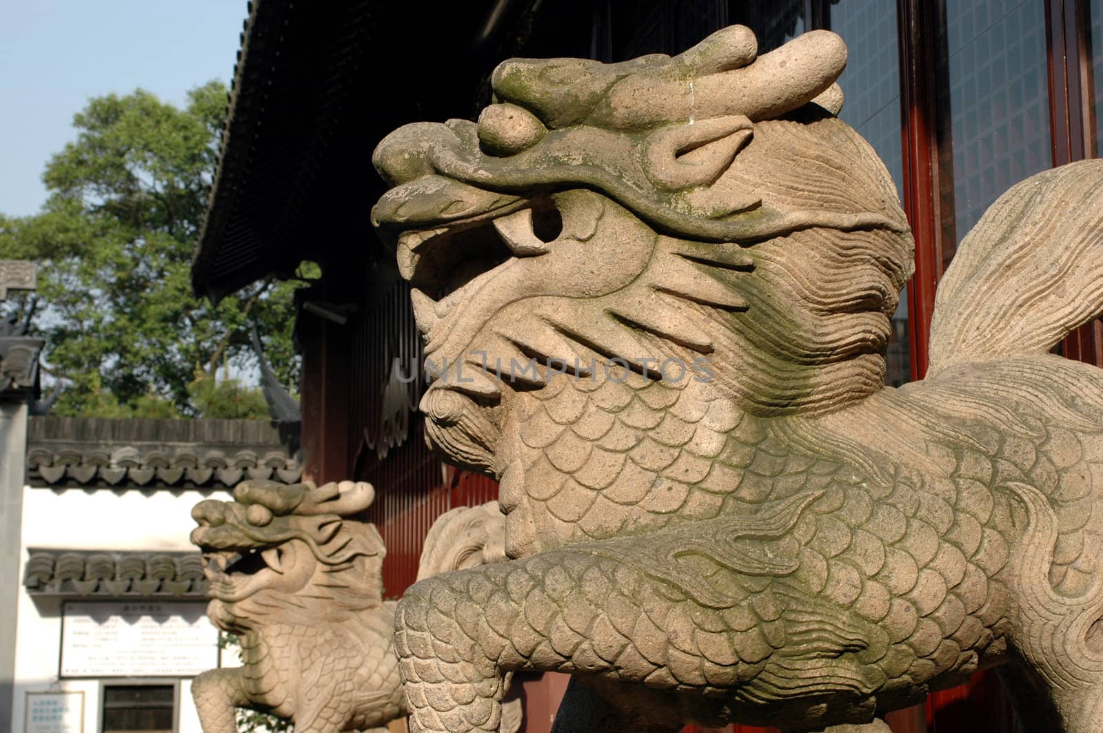 China, Shanghai, old town Cheng Huang Miao. Entrance to building guarded by two dragons, sculpture made of stone.