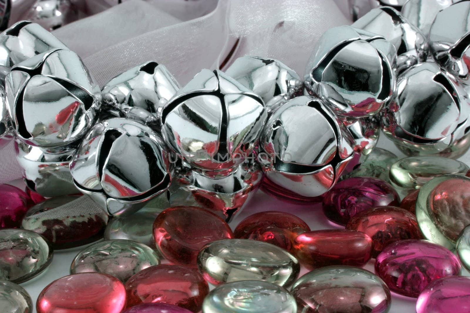 Silver Christmas bells with red glass stones.
