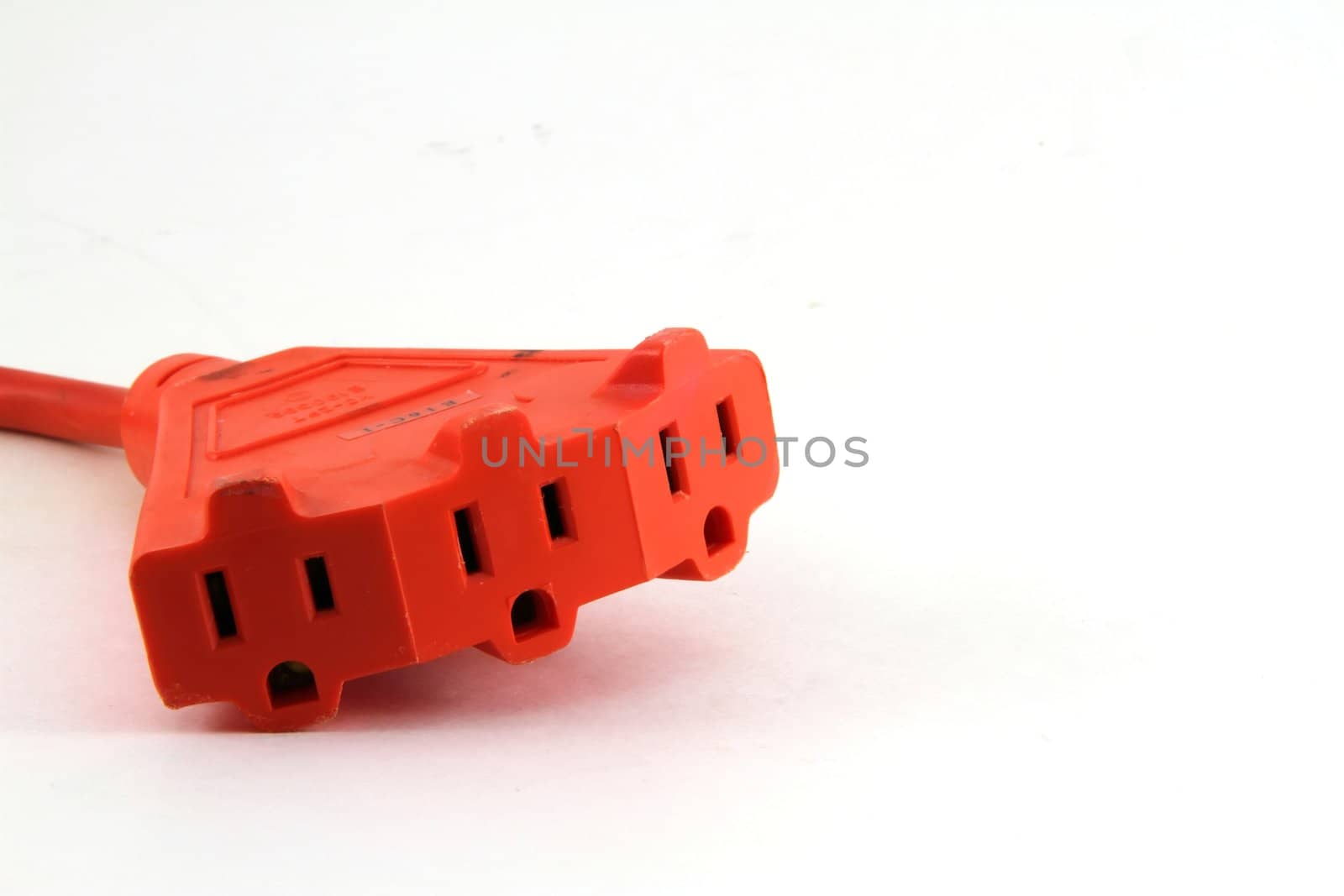 A triple socket extension cord isolated on white.