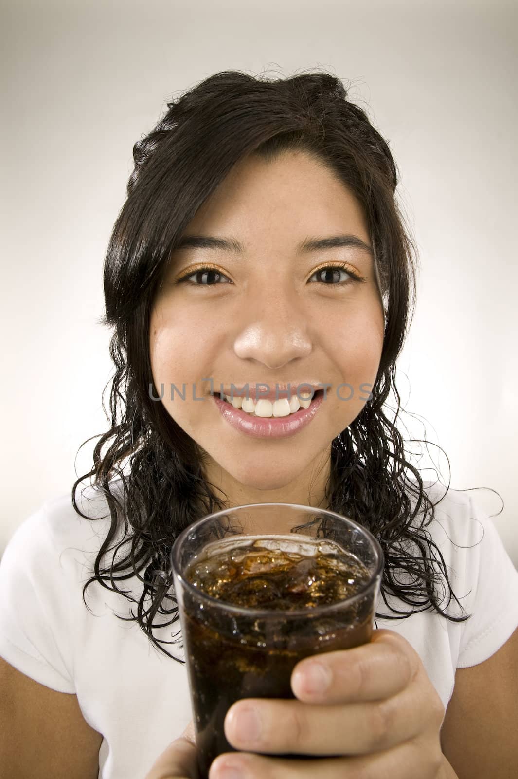 Portrait of a Latina with a cup of iced soda.